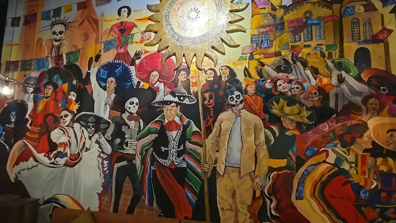 Day-of-the-Dead mural with skeleton mariachis and dancers